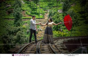 Couple Posing In rail track with umbrella